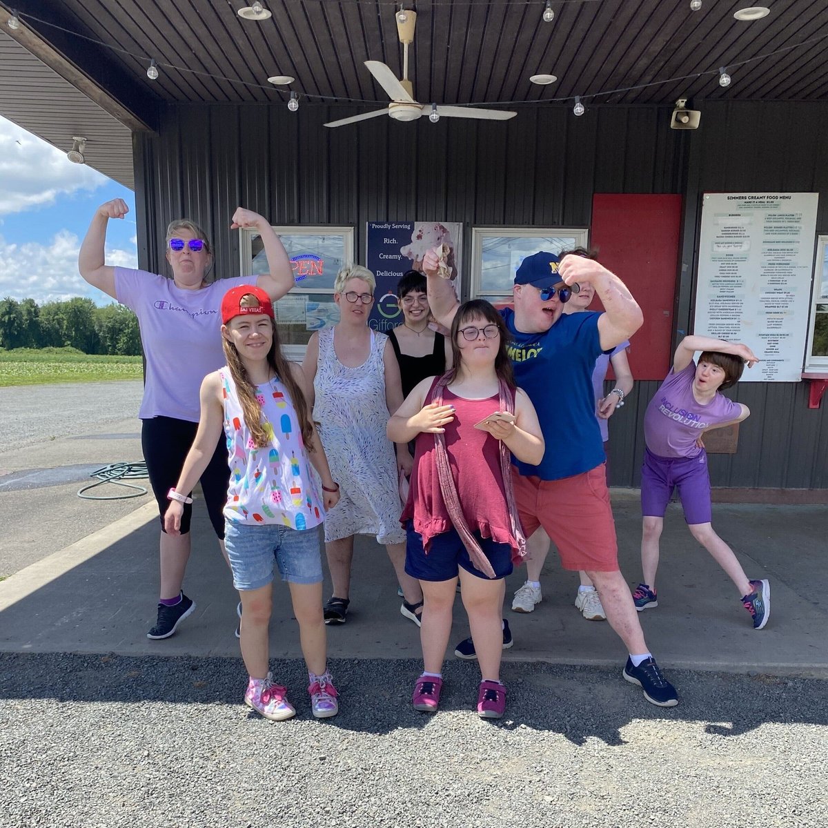 The Milestones Day program group poses for a photo before getting ice cream on a hot summer day.